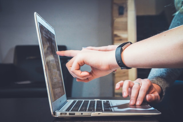 pointing at computer in school