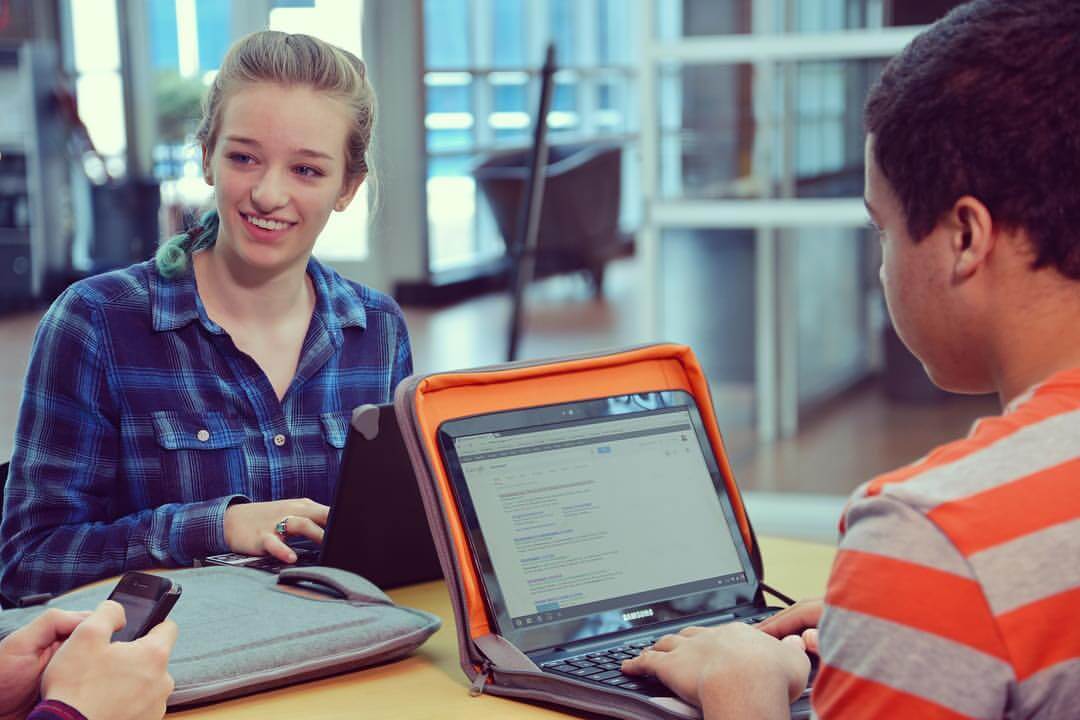 students using higher ground cases with laptops in cafeteria