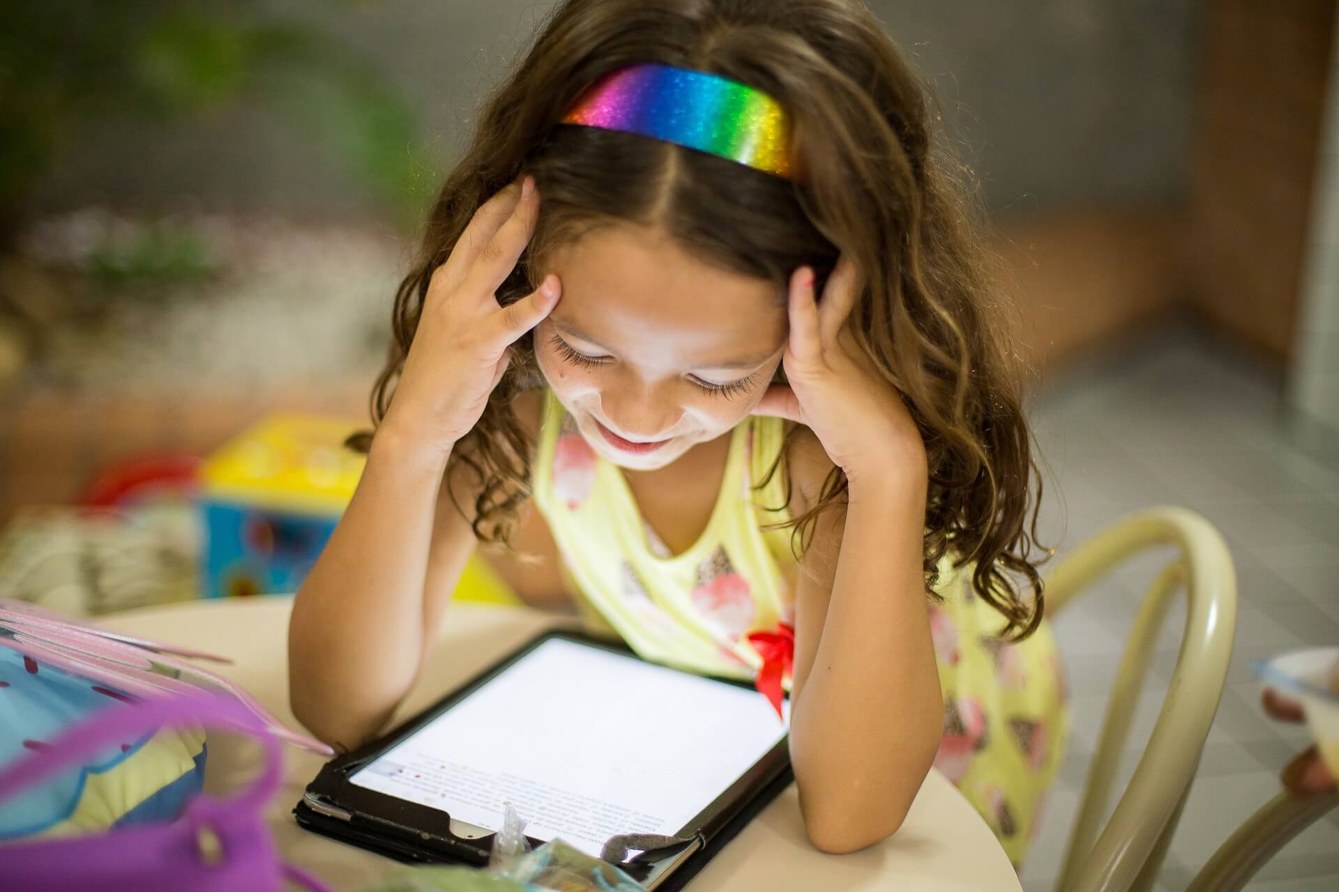 little girl looking at tablet