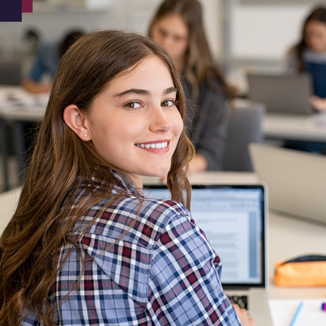 girl using laptop looking over shoulder