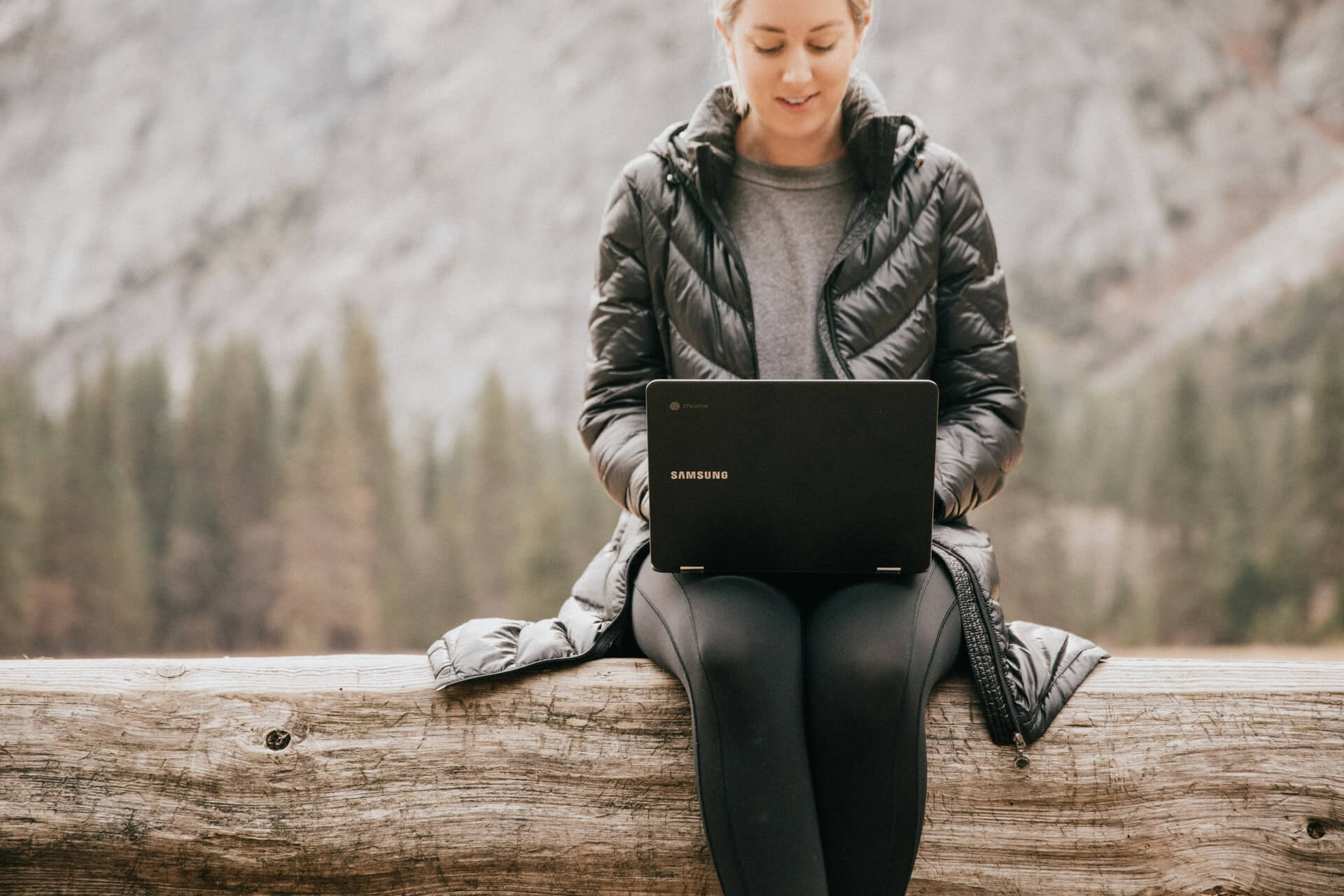 girl sitting outdoors on laptop