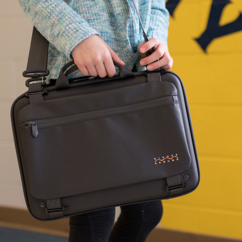 student carrying shuttle case with added power pocket