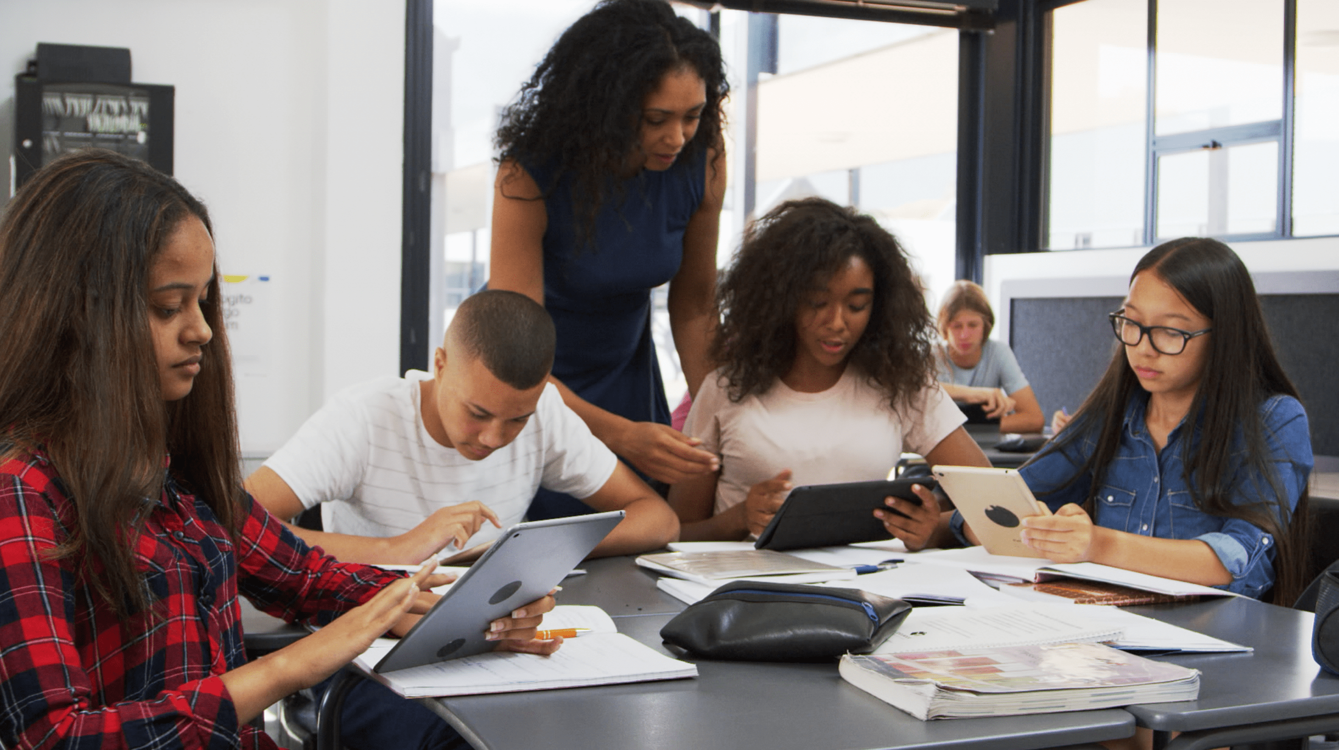 teacher with students using tablets