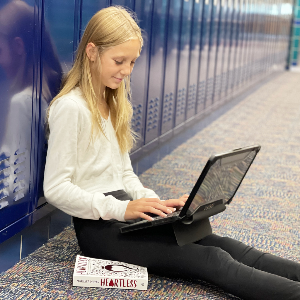 girl sitting in locker hallway with shockguard
