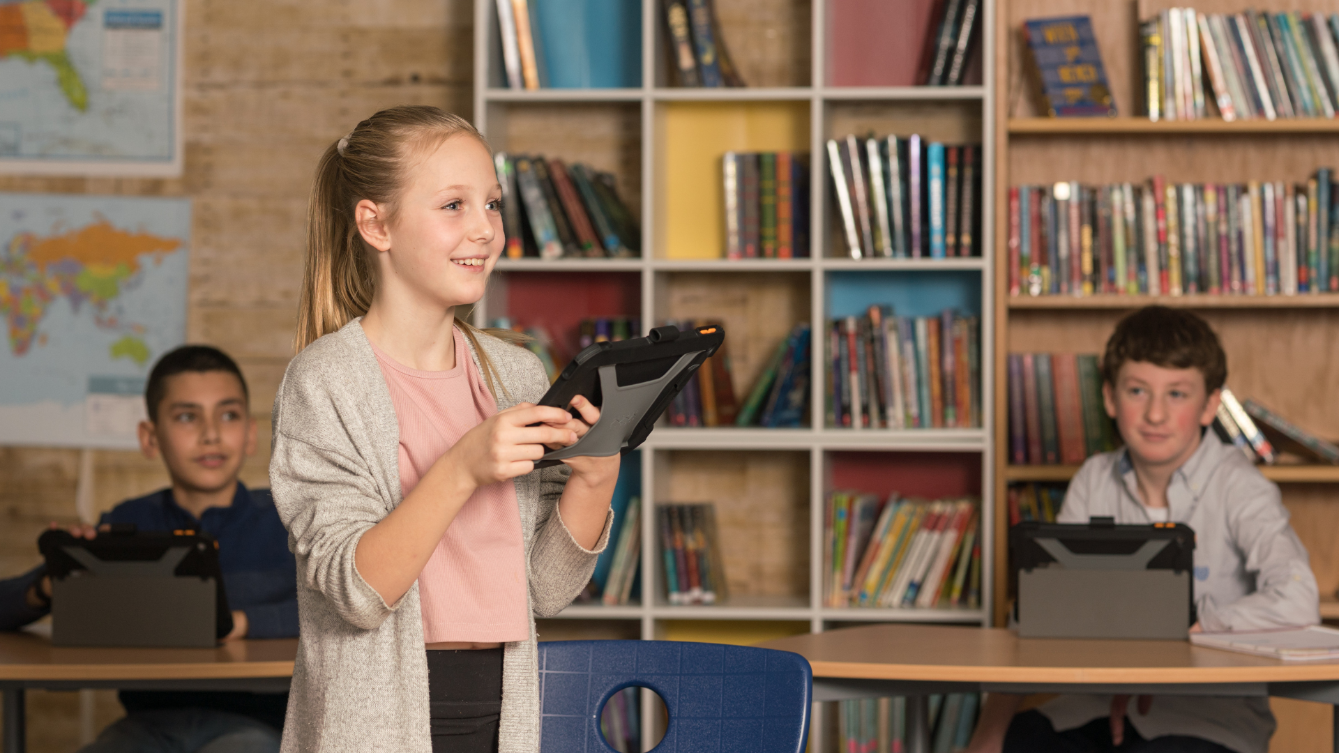student standing in classroom using protex on ipad