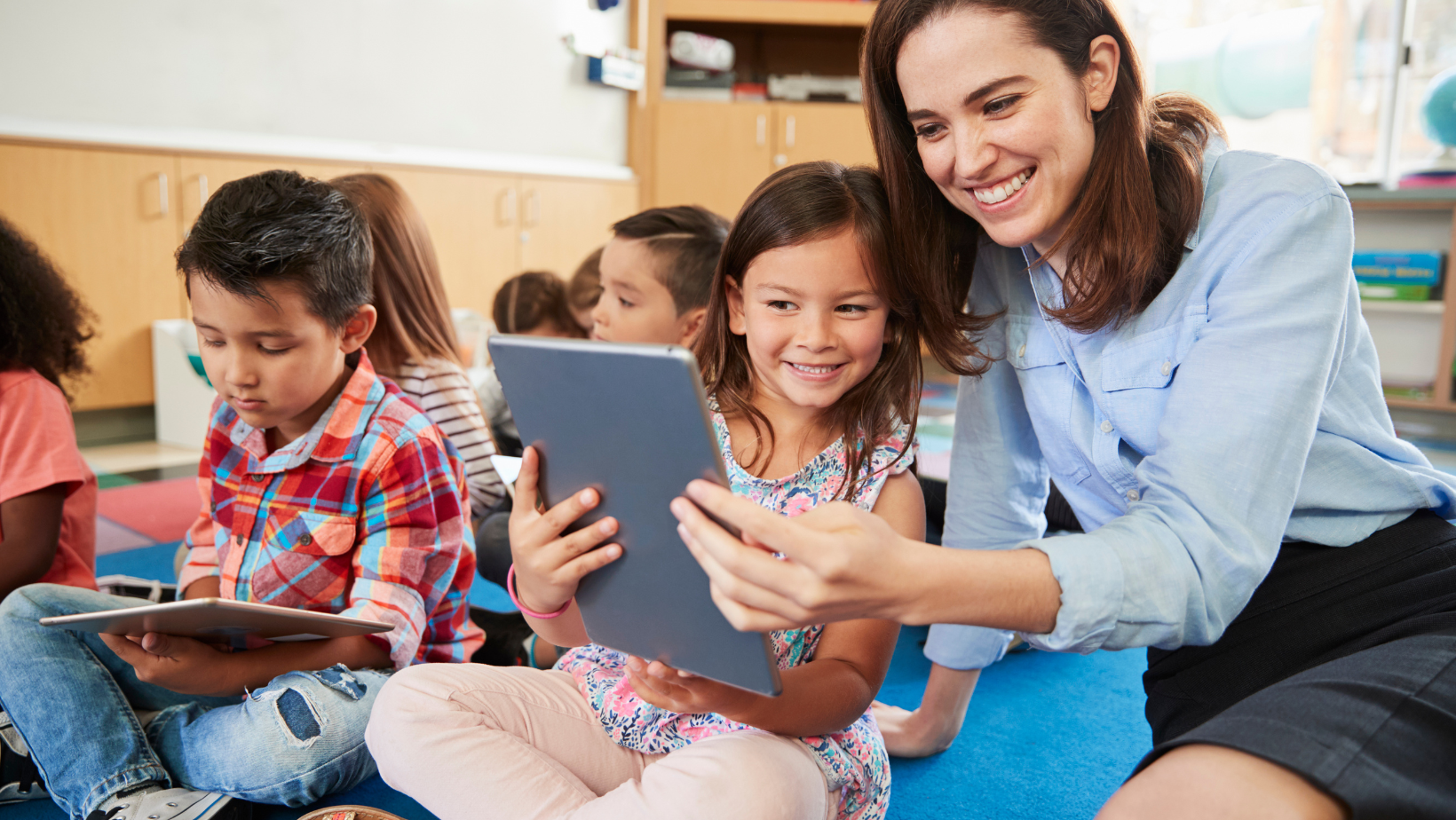 student with teacher looking at tablet