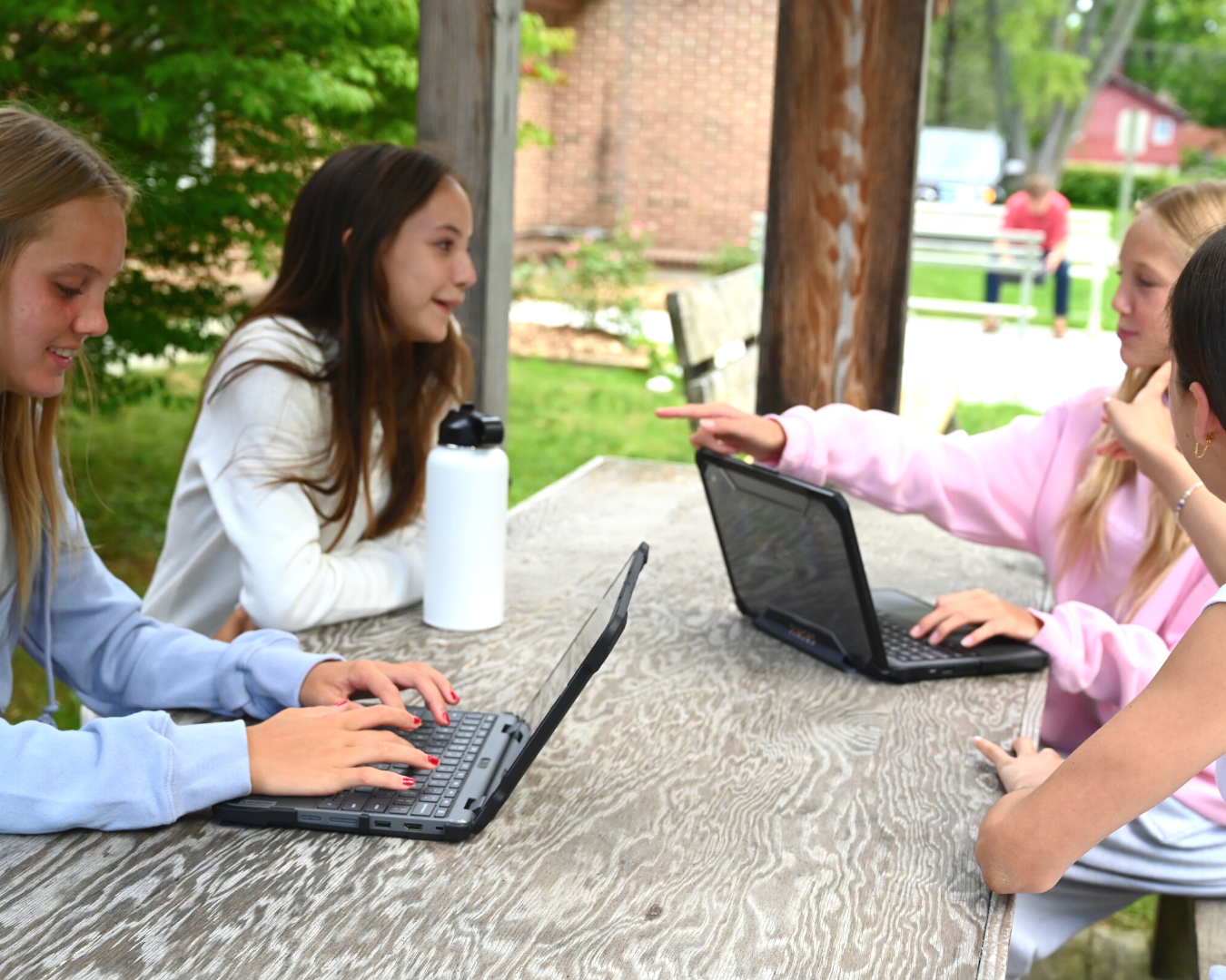 girls at school tables using shockguard collection