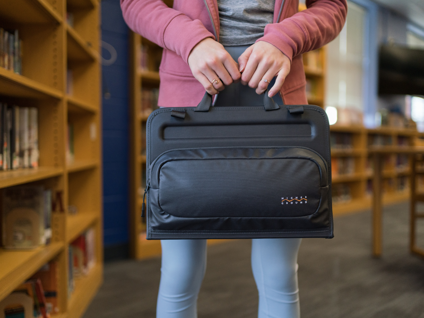 student in school library holding datakeeper plus cleanshell